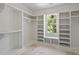 Bright closet with built-in shelving, hanging racks, and a window for natural light at 1229 Dixie Trl, Raleigh, NC 27607