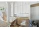 The kitchen shows white cabinets and an island that opens up to the staircase at 1229 Dixie Trl, Raleigh, NC 27607