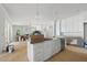 Spacious white kitchen with large island, stainless steel appliances, and open floor plan at 1229 Dixie Trl, Raleigh, NC 27607