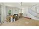 Spacious living room with fireplace, large windows, and staircase leading to the second floor at 1229 Dixie Trl, Raleigh, NC 27607