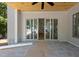 Covered patio with gray stone tile and sliding glass doors leading to the interior at 1229 Dixie Trl, Raleigh, NC 27607
