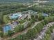 Aerial view of a community featuring a pool, tennis courts, clubhouse, and well-maintained landscaping at 12412 Mayhurst Pl, Raleigh, NC 27614