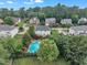 An aerial showcases a beautiful home with a large pool and well-manicured backyard at 12412 Mayhurst Pl, Raleigh, NC 27614