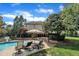 Inviting backyard boasts a sparkling pool, patio with lounge chairs, and lush landscaping at 12412 Mayhurst Pl, Raleigh, NC 27614
