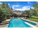 Large backyard pool with diving board, mature trees, deck area, and privacy landscaping at 12412 Mayhurst Pl, Raleigh, NC 27614