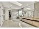 Bright bathroom with a glass-enclosed shower, double vanity, large mirrors, and tile flooring at 12412 Mayhurst Pl, Raleigh, NC 27614