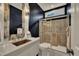 Modern bathroom with a glass-enclosed shower, a vessel sink, a dark accent wall, and tile flooring at 12412 Mayhurst Pl, Raleigh, NC 27614