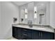 Modern bathroom featuring double sinks, granite counters, and decorative lighting at 12412 Mayhurst Pl, Raleigh, NC 27614