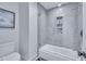 Elegant bathroom featuring a tub/shower and tiled walls at 12412 Mayhurst Pl, Raleigh, NC 27614