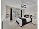 Well-lit bedroom with neutral walls and white furnishings at 12412 Mayhurst Pl, Raleigh, NC 27614