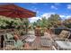 Relaxing deck features comfortable seating, umbrella, and outdoor grill perfect for entertaining at 12412 Mayhurst Pl, Raleigh, NC 27614