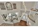 Elegant foyer with an open staircase, stylish light fixtures, and a view of the living room at 12412 Mayhurst Pl, Raleigh, NC 27614