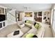 Open-concept living area with hardwood floors, large sectional couch, and an eat-in kitchen nearby at 12412 Mayhurst Pl, Raleigh, NC 27614
