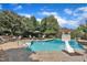 Beautiful pool surrounded by lush greenery and comfortable seating at 12412 Mayhurst Pl, Raleigh, NC 27614