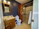 Bathroom featuring a glass shower, toilet, mirror, sink, and linen closet at 1306 Oakridge Ave, Henderson, NC 27536