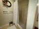 Shower-tub combo with patterned wallpaper and towel bar at 1306 Oakridge Ave, Henderson, NC 27536