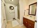 Bathroom featuring vanity, mirror, patterned wallpaper, and shower-tub combo at 1306 Oakridge Ave, Henderson, NC 27536