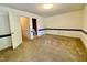 Bright bedroom with neutral carpet, clean lines, and access to a bathroom, offering a peaceful retreat at 1306 Oakridge Ave, Henderson, NC 27536