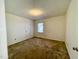 Bedroom featuring window, carpeted floor, and neutral walls at 1306 Oakridge Ave, Henderson, NC 27536
