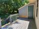 Open porch featuring a door and stairs going down to the backyard at 1306 Oakridge Ave, Henderson, NC 27536