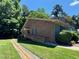 Two-story brick and siding home with a wheelchair ramp and manicured landscaping beneath a clear sky at 1306 Oakridge Ave, Henderson, NC 27536