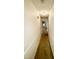 Well-lit hallway with neutral paint, carpeted floors, and trim, leading to various rooms in the house at 1306 Oakridge Ave, Henderson, NC 27536