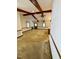 Comfortable living area with beamed ceilings, carpeted floors, and large windows for ample natural light at 1306 Oakridge Ave, Henderson, NC 27536