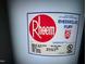 Close-up of a Rheem Fury water heater with detailed specifications and manufacturing information at 1306 Oakridge Ave, Henderson, NC 27536