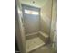 New bathroom with a tiled shower featuring a bench, shower head, and a window at 140 Sawtooth Oak Ln, Youngsville, NC 27596