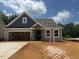 Charming single-Gathering home with stone accents, a two-car garage and a 'SOLD' sign in the window at 140 Sawtooth Oak Ln, Youngsville, NC 27596