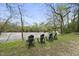 Inviting backyard featuring a row of chairs facing a scenic river view, perfect for relaxation and enjoying nature at 1500 River Mill Dr # 310, Wake Forest, NC 27587