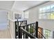 Second floor hallway featuring stain glass art with staircase and natural lighting at 1500 River Mill Dr # 310, Wake Forest, NC 27587