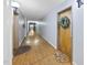 Hallway with hardwood floors and neutral-colored walls and decorative door mats at 1500 River Mill Dr # 310, Wake Forest, NC 27587