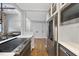 Modern kitchen with stainless appliances, white cabinets, a breakfast bar, and easy access to the dining area at 1500 River Mill Dr # 310, Wake Forest, NC 27587