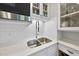 Modern kitchen featuring stainless steel appliances, white cabinets, subway tile backsplash, and a double-basin sink at 1500 River Mill Dr # 310, Wake Forest, NC 27587