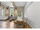 Bright living room with dining area featuring stone walls, hardwood floors, beamed ceilings, and lots of natural light at 1500 River Mill Dr # 310, Wake Forest, NC 27587