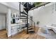 Bright living space with a spiral staircase, hardwood floors, and an open layout connecting to the kitchen area at 1500 River Mill Dr # 310, Wake Forest, NC 27587