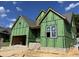 Two-story home construction showing exterior framework, brick foundation and a garage space, all under a clear blue sky at 152 Big Bradley Dr, Wendell, NC 27591