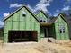 New construction home featuring a two-car garage, brick accents, and visible framework ready for customization at 152 Big Bradley Dr, Wendell, NC 27591