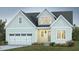 Charming home boasts a light blue exterior, well-manicured lawn, and a two-car garage for modern living at 152 Big Bradley Dr, Wendell, NC 27591