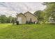 Back view of house showing siding, satellite, and backyard at 1726 Morgantown Rd, Burlington, NC 27217