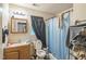 Modest bathroom featuring a single sink vanity, toilet, and shower/tub combination at 1726 Morgantown Rd, Burlington, NC 27217