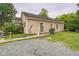 Home exterior featuring a gravel driveway, well-kept lawn, and convenient side entry at 1726 Morgantown Rd, Burlington, NC 27217