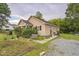 Inviting home exterior with lush landscaping, gravel driveway, and charming details at 1726 Morgantown Rd, Burlington, NC 27217