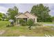Cozy home featuring well-maintained landscaping, lawn equipment, and inviting charm at 1726 Morgantown Rd, Burlington, NC 27217
