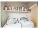 Functional laundry area with washer, dryer, and shelving for storage at 1726 Morgantown Rd, Burlington, NC 27217