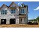 New construction home with covered entrance and multiple windows awaiting final construction touches at 173 Ripple Way # 204, Clayton, NC 27520