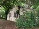 Close up shot showcasing the side of the house with rustic shutters, plants, and siding texture at 1806 Rendall St, Burlington, NC 27215