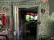 Shows a view into a living room needing extensive repair and cleaning at 1806 Rendall St, Burlington, NC 27215