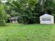 Expansive yard featuring the home and a detached garage providing ample space and storage at 1806 Rendall St, Burlington, NC 27215